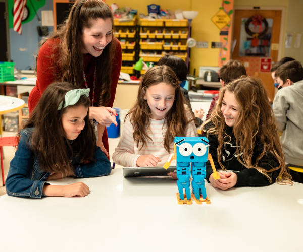 Three girls learning programming through Marty the Robot