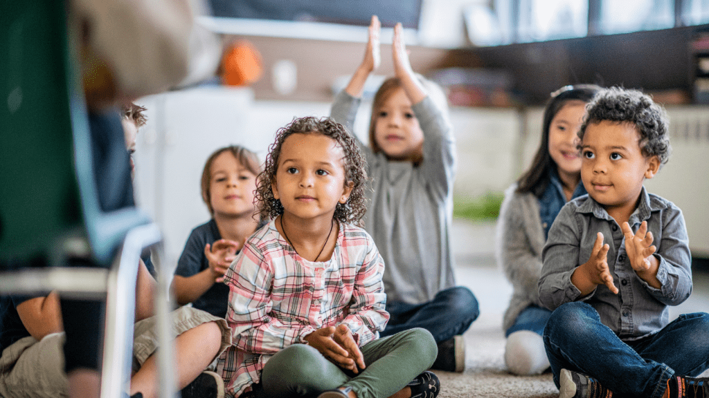 Kindergarten children clapping hands